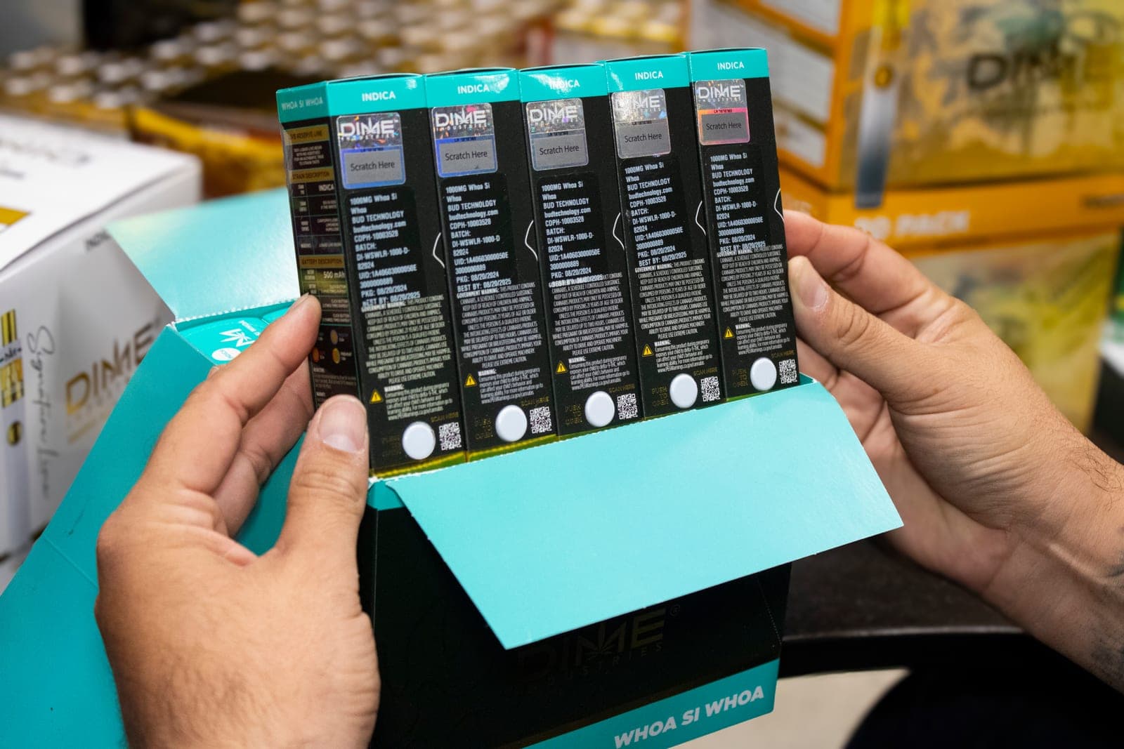 Bud Technology distributed all-in-one vapes showing METRC batch and CDPH license details on the packaging